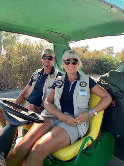 Two people inside a golf cart